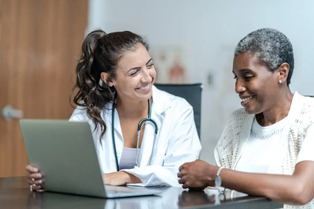 Young Female Doctor with Elderly Patient stock photo
